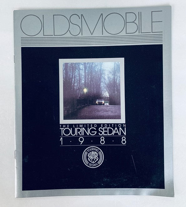 1988 Oldsmobile Touring Sedan Dealer Showroom Sales Brochure Cover, featuring a limited edition design and an image of the vehicle, ideal for collectors and automotive enthusiasts.