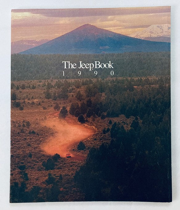 Cover of the 1990 Jeep Book Dealer Showroom Sales Brochure Guide Catalog showcasing a scenic mountain landscape with a dirt road, emphasizing Jeep's adventure and outdoor themes.