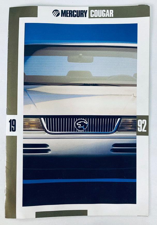 1992 Mercury Cougar Dealer Showroom Sales Brochure Guide Catalog featuring a close-up view of the vehicle's front end, highlighting its distinctive grille and sleek design.