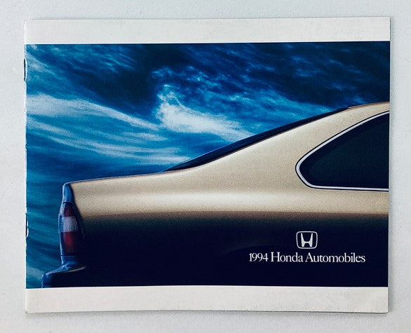 Cover of the 1994 Honda Automobiles Dealer Showroom Sales Brochure, featuring the sleek rear profile of a Honda vehicle against a dramatic blue sky.