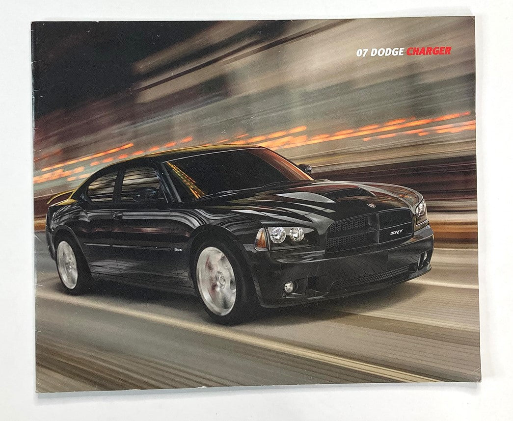 2007 Dodge Charger Dealer Showroom Sales Brochure Guide Catalog featuring a sleek black Dodge Charger in motion, showcasing its powerful design and performance.