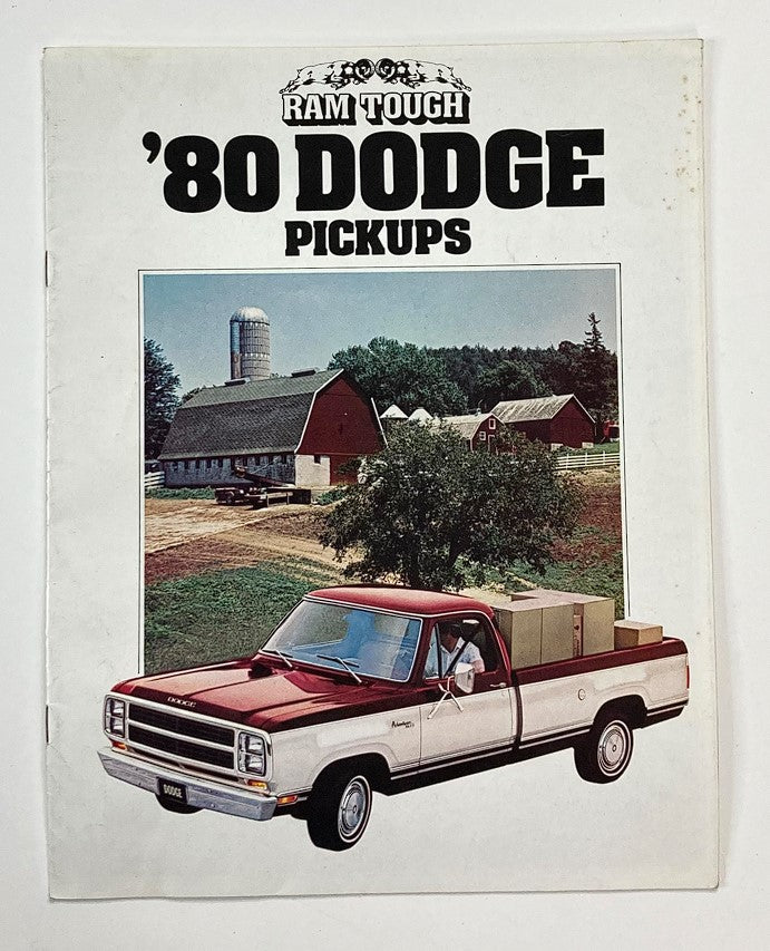 1980 Dodge Pickups Dealer Showroom Sales Brochure Cover featuring a Dodge pickup truck parked in front of a farm, showcasing classic American automotive design and nostalgia.