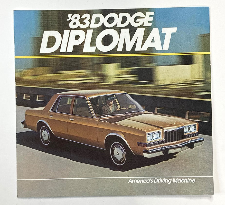 1983 Dodge Diplomat Dealer Showroom Sales Brochure Guide Catalog featuring a classic Dodge Diplomat car on a highway, showcasing its design and prominence as America's Driving Machine.