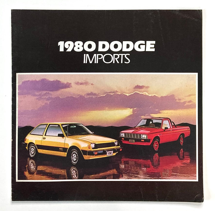Cover of the 1980 Dodge Imports Ram Tough Dealer Showroom Sales Brochure Guide Catalog featuring a yellow hatchback and a red pickup against a sunset backdrop.