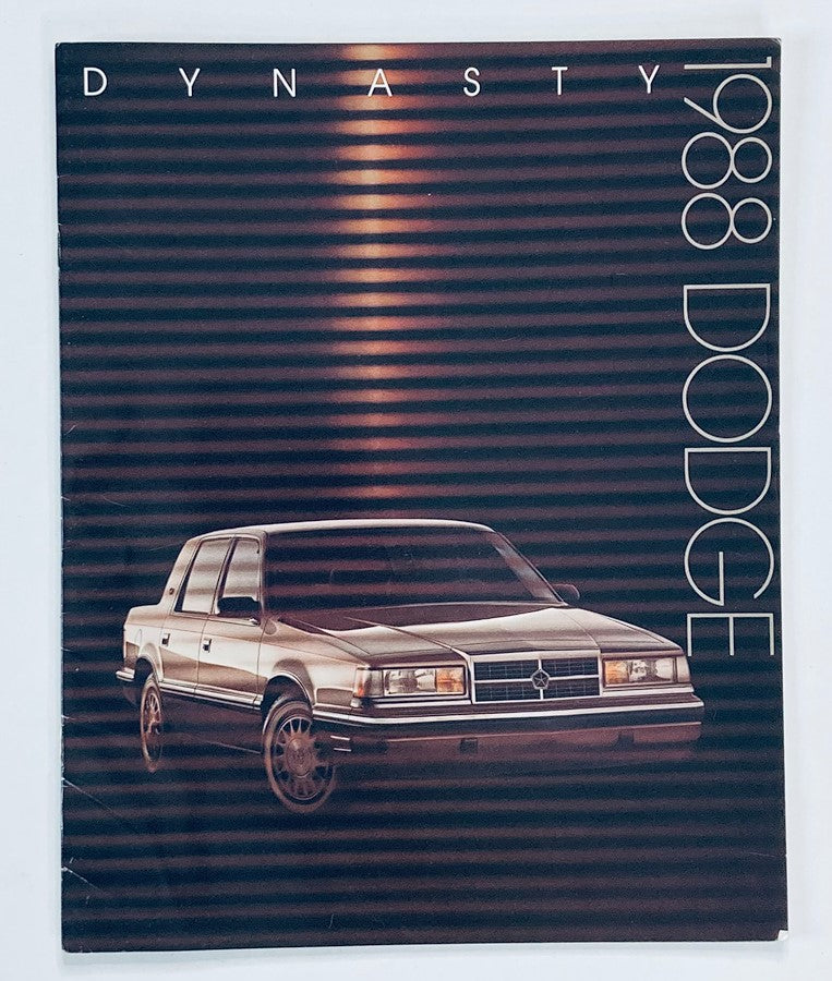 1988 Dodge Dynasty Dealer Showroom Sales Brochure Guide Catalog featuring a stylish front view of the car on a sleek striped background.