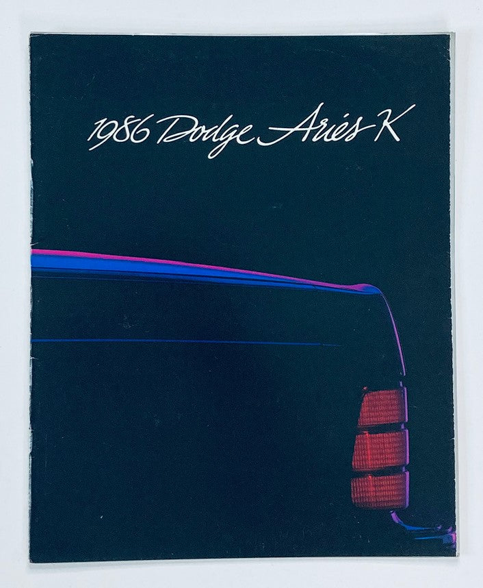 1986 Dodge Aries K Dealer Showroom Sales Brochure Cover featuring a sleek design with a focus on the car's distinctive rear profile and vibrant color scheme.
