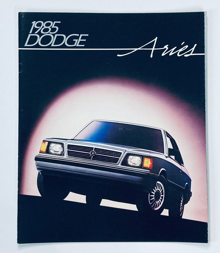 Cover image of the 1985 Dodge Aries Dealer Showroom Sales Brochure Guide Catalog featuring a sleek design of the Dodge Aries car with a dark background.