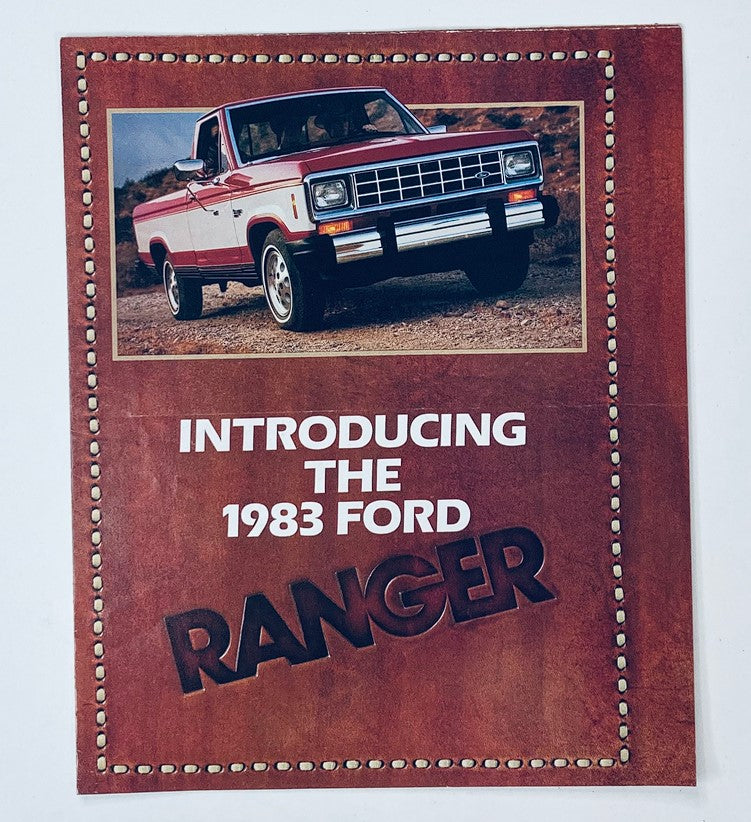 Cover of the 1983 The Ford Ranger Dealer Showroom Sales Brochure with a red and white Ford Ranger truck on a dirt road.