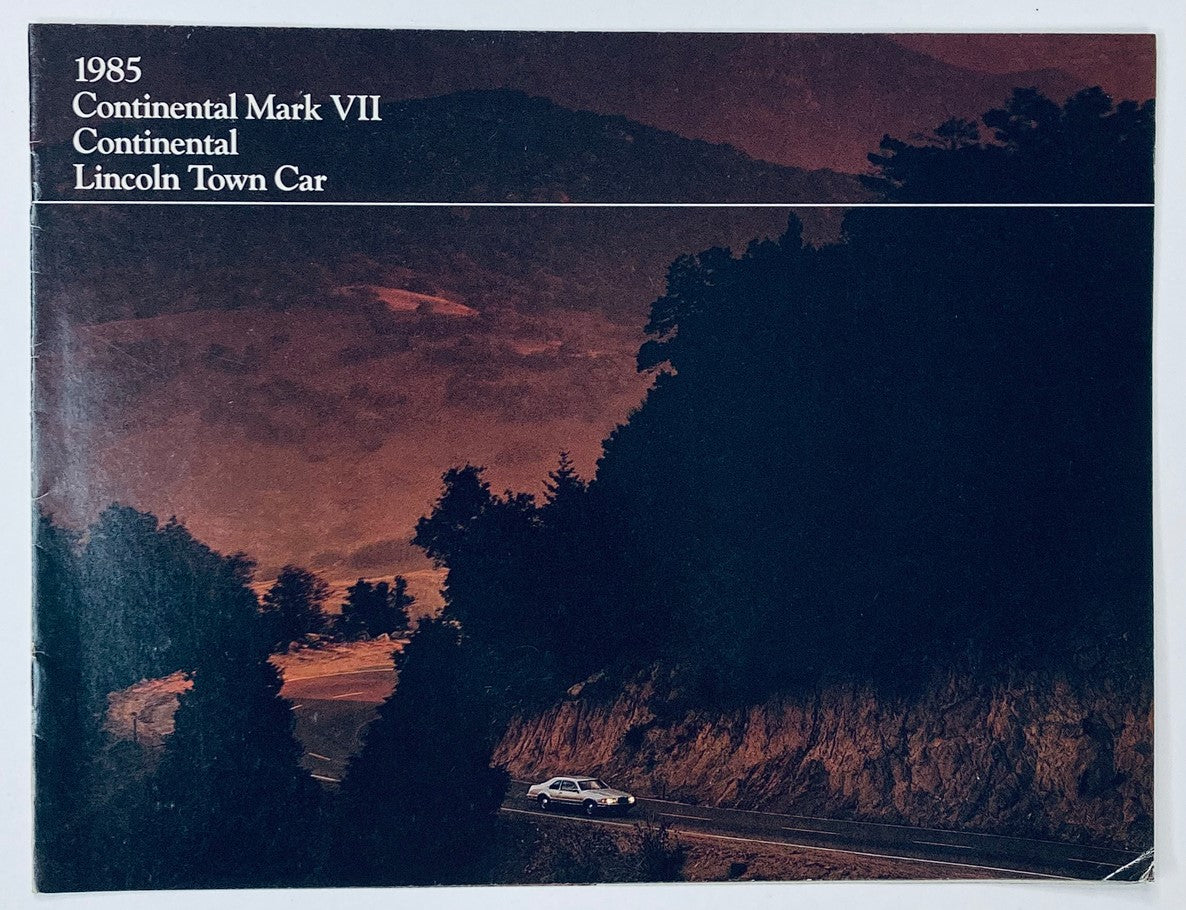 1985 Lincoln Continental Dealer Showroom Sales Brochure Guide Catalog cover featuring a scenic view with a Lincoln Town Car on a winding road through a mountainous landscape.