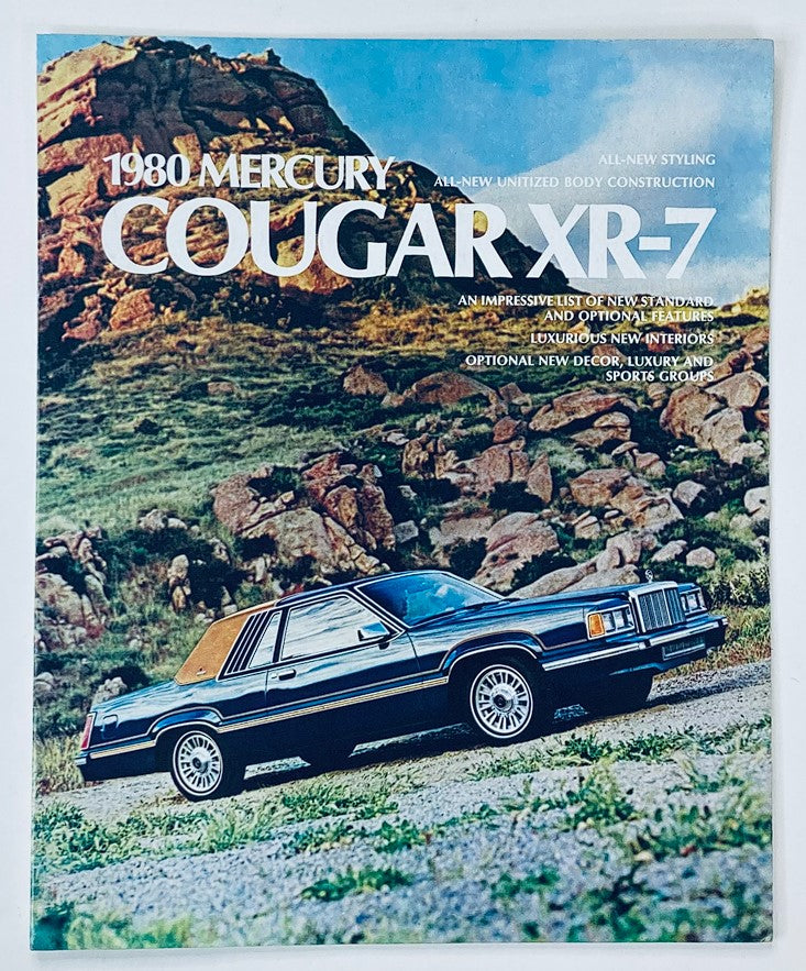 1980 Mercury Cougar XR-7 Dealer Showroom Sales Brochure showcasing the car on a scenic landscape, highlighting its unique body construction and new styling features.