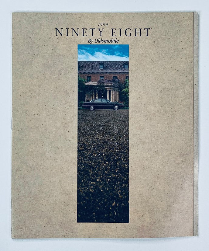 Cover of the 1994 Oldsmobile Ninety Eight Dealer Showroom Sales Brochure Guide Catalog featuring a photograph of the vehicle in front of a grand estate.
