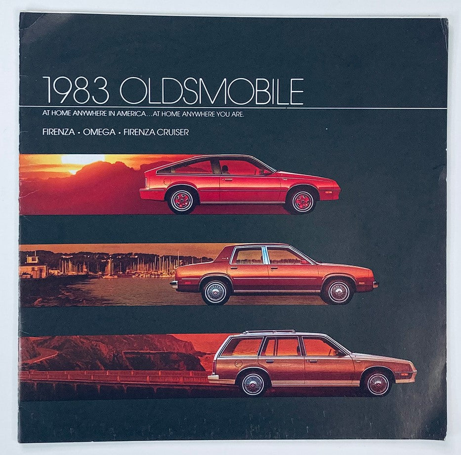 1983 Oldsmobile Firenza, Omega Dealer Showroom Sales Brochure Cover featuring three car models: Firenza, Omega, and Firenza Cruiser against a scenic sunset backdrop.