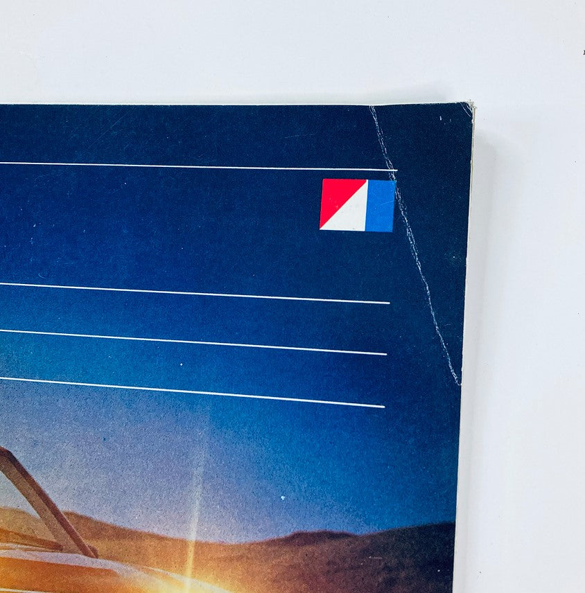 Close-up of the cover page from the 1983 American Motors SX/4 Dealer Showroom Sales Brochure displaying the logo and design elements in a blue background.