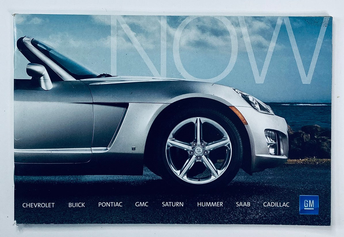 2000s GM Chevrolet, Pontiac Dealer Showroom Sales Brochure Guide Catalog featuring a close-up view of a silver convertible car with a scenic background, showcasing vehicle brands like Chevrolet, Buick, Pontiac, GMC, Saturn, Hummer, Saab, and Cadillac.