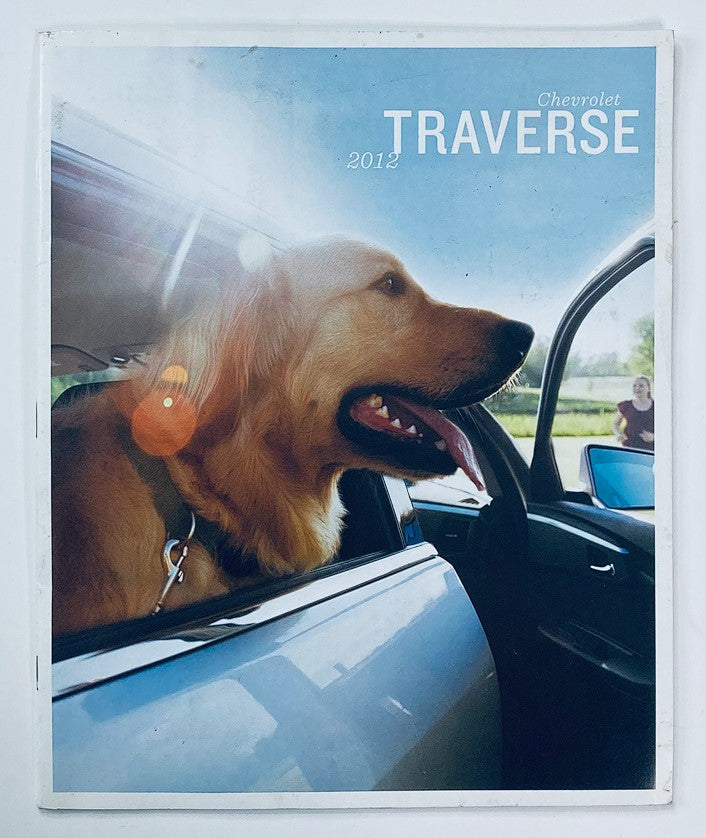 2012 Chevrolet Traverse Dealer Showroom Sales Brochure Cover featuring a golden retriever in a car window, highlighting the pet-friendly features of the vehicle.