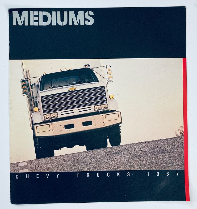 1987 Chevrolet Medium Trucks Dealer Showroom Sales Brochure Guide Catalog showcasing a Chevrolet truck on a road, highlighting the front view and model details.