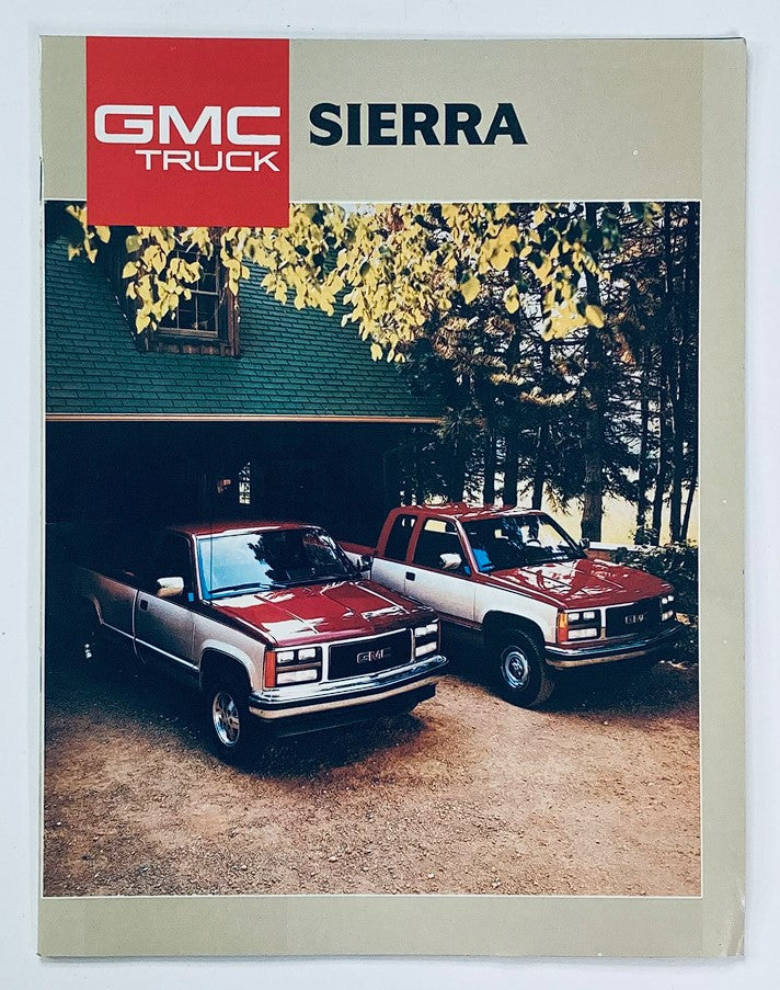 Cover of the 1988 GMC Truck Sierra Dealer Showroom Sales Brochure showcasing two GMC Sierra trucks parked in front of a wooden cabin surrounded by trees, highlighting the vintage design and iconic features of the vehicle.