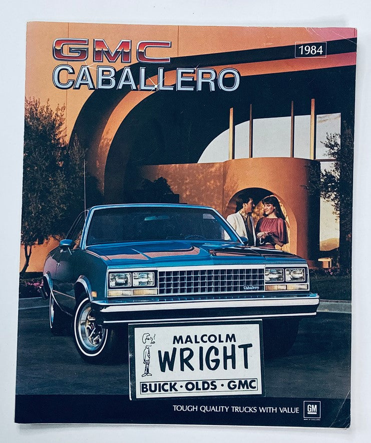 1984 GMC Caballero Dealer Showroom Sales Brochure Guide Catalog featuring a blue GMC Caballero parked in front of a modern architectural backdrop with two people. The brochure highlights the vehicle's style and brand, emphasizing quality and value.