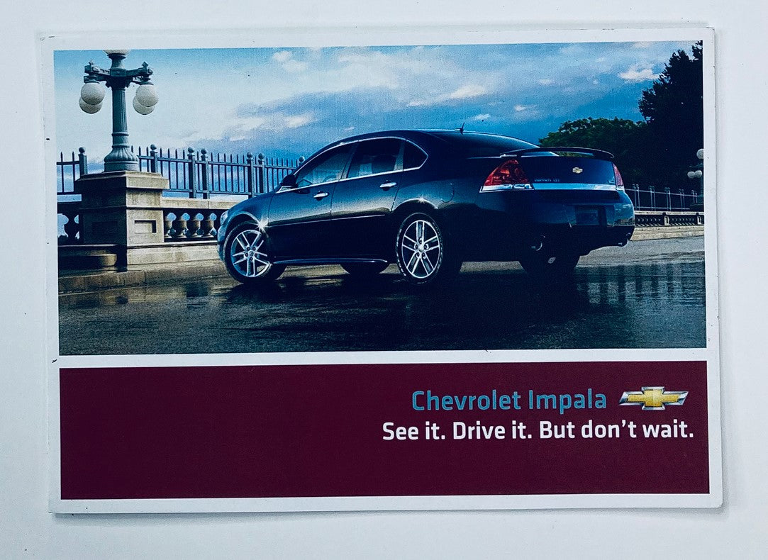 2000s Chevrolet Impala Dealer Showroom Sales Brochure image featuring a sleek black Chevrolet Impala parked in an elegant setting, showcasing the tagline 'See it. Drive it. But don’t wait.'