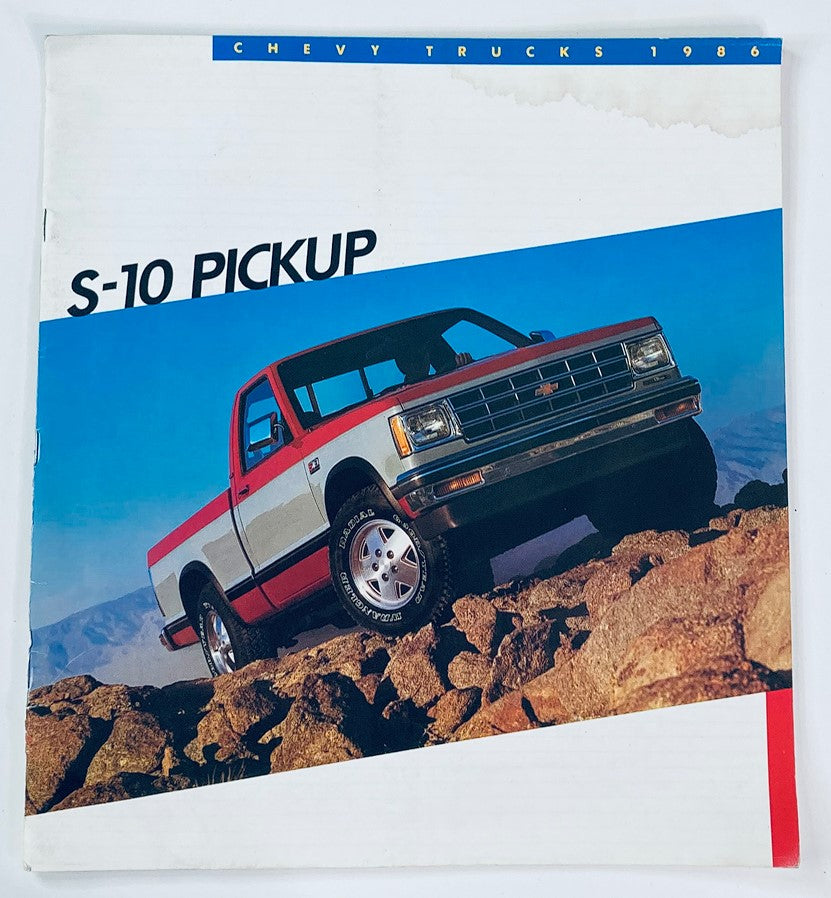 1986 Chevrolet S-10 Pickup Dealer Showroom Sales Brochure showcasing a red and white Chevy S-10 Pickup truck on rocky terrain, highlighting its design and features.