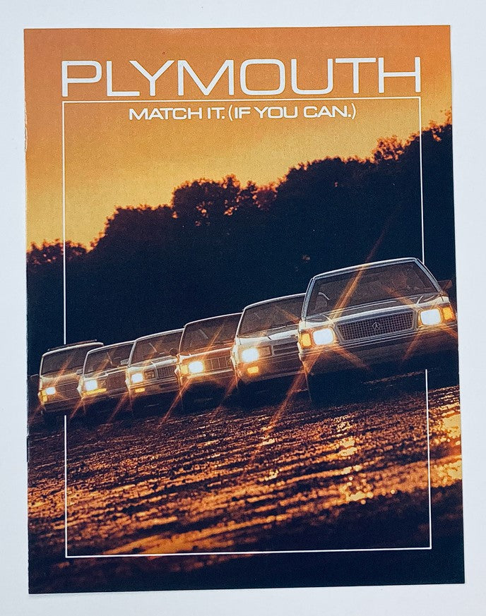 Cover image of the 1985 Plymouth Range Dealer Showroom Sales Brochure Guide Catalog featuring a lineup of Plymouth cars on a scenic background with the tagline 'Match It. (If You Can.)' and bold branding.