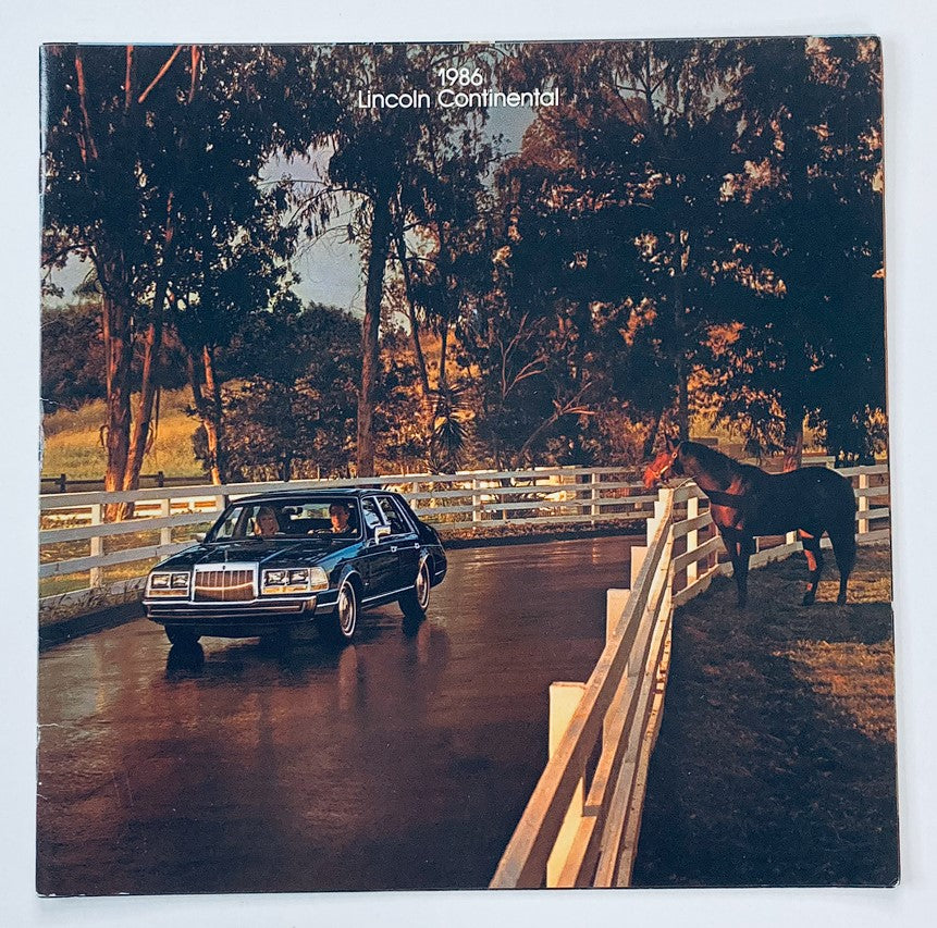 1986 Lincoln Continental Dealer Showroom Sales Brochure Guide Catalog featuring a 1986 Lincoln Continental parked near a horse on a scenic driveway.