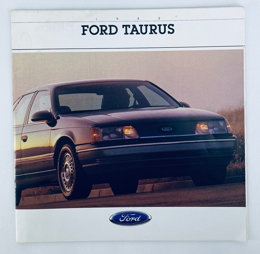 1988 Ford Taurus Dealer Showroom Sales Brochure showcasing the iconic Ford Taurus vehicle, featuring a photograph of the car in a scenic background with prominent headlights and classic design.