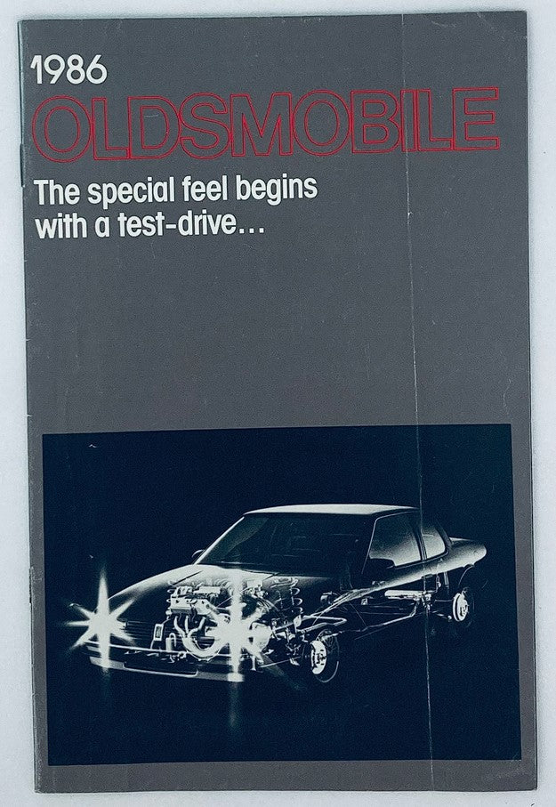 1986 Oldsmobile Full Line Dealer Showroom Sales Brochure featuring a sleek car image, promoting the special feel of driving an Oldsmobile.