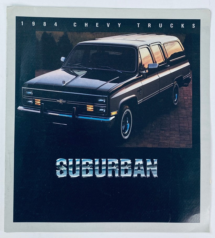 1984 Chevrolet Trucks Suburban Dealer Showroom Sales Brochure featuring a vintage Chevy Suburban vehicle, showcasing its design and style from the 1980s with a sleek exterior and bold 'SUBURBAN' text.