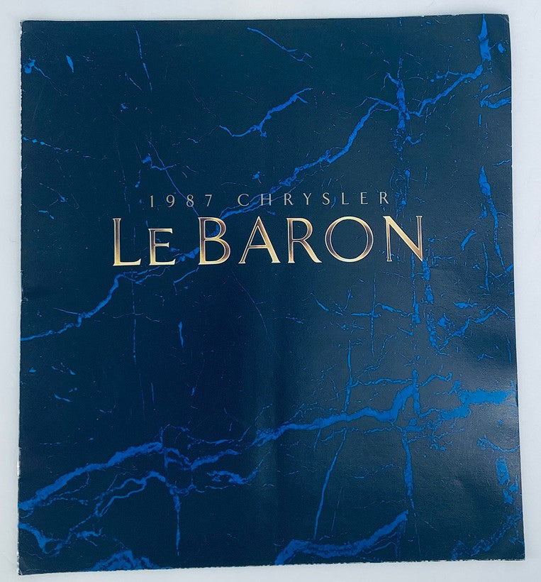 Cover of the 1987 Chrysler Le Baron Dealer Showroom Sales Brochure Guide Catalog featuring a blue marble design and the title '1987 Chrysler Le Baron' in gold lettering.