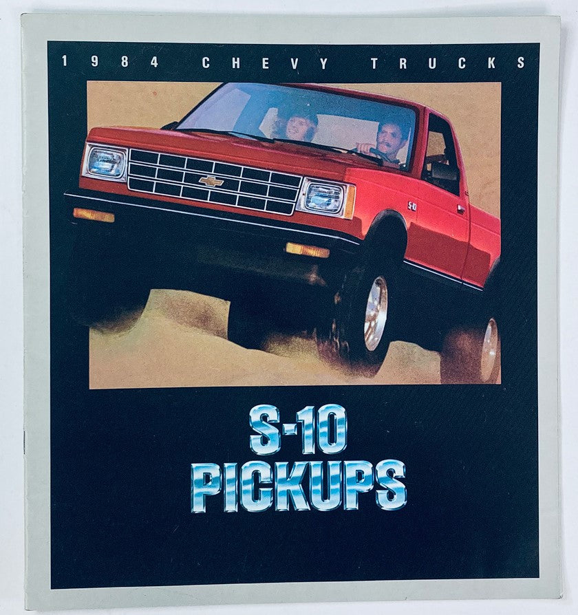 1984 Chevrolet Trucks S-10 Pickups Dealer Showroom Sales Brochure featuring a red S-10 pickup truck in action with passengers, showcasing the vehicle's design and appeal.