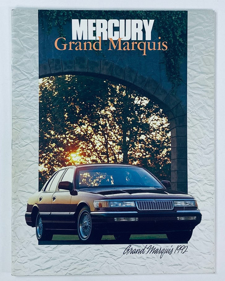 1992 Mercury Grand Marquis Dealer Showroom Sales Brochure featuring a sleek black Grand Marquis car parked under a scenic archway with sunset lighting.