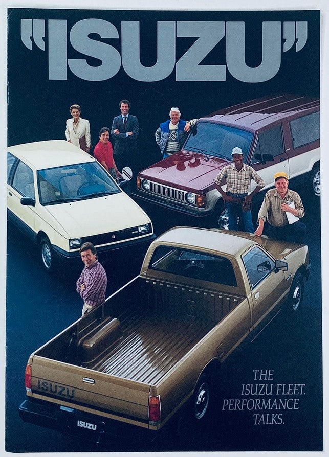 1986 Isuzu Full Line Up Dealer Showroom Sales Brochure Guide Catalog featuring a diverse lineup of Isuzu vehicles, including a truck, SUV, and car showcased with a group of people around them.