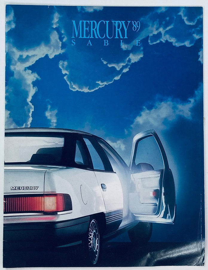 Cover of the 1989 Mercury Sable Full Line Dealer Showroom Sales Brochure Guide Catalog, featuring a sleek white Mercury Sable car against a cloudy blue sky background.
