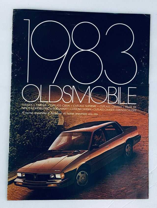 Cover of the 1983 Oldsmobile Full Lineup Dealer Showroom Sales Brochure showcasing a vintage Oldsmobile vehicle against a scenic background, featuring the title prominently.