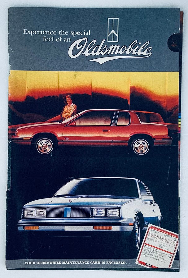 1980s Oldsmobile Lineup Dealer Showroom Sales Brochure featuring a classic Oldsmobile vehicle and promotional imagery, showcasing the elegance and style of this era.