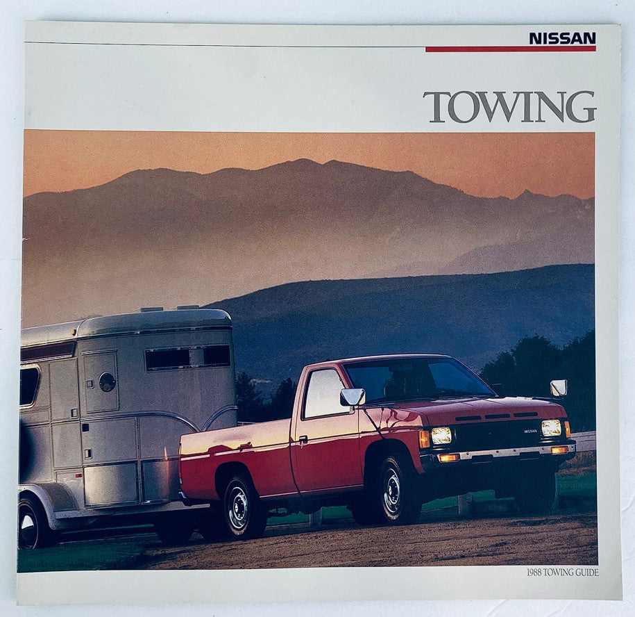 1988 Nissan Towing Dealer Showroom Sales Brochure Guide Catalog featuring a red Nissan pickup truck towing a trailer against a scenic mountainous background.