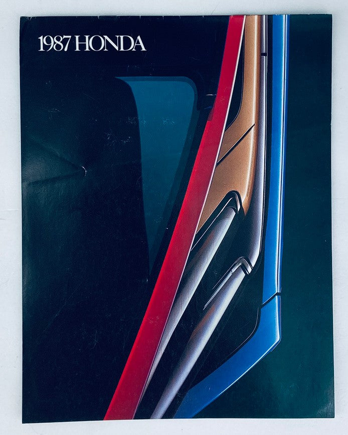 Cover of the 1987 Honda Lineup Dealer Showroom Sales Brochure Guide Catalog featuring a sleek modern design with vibrant colors.