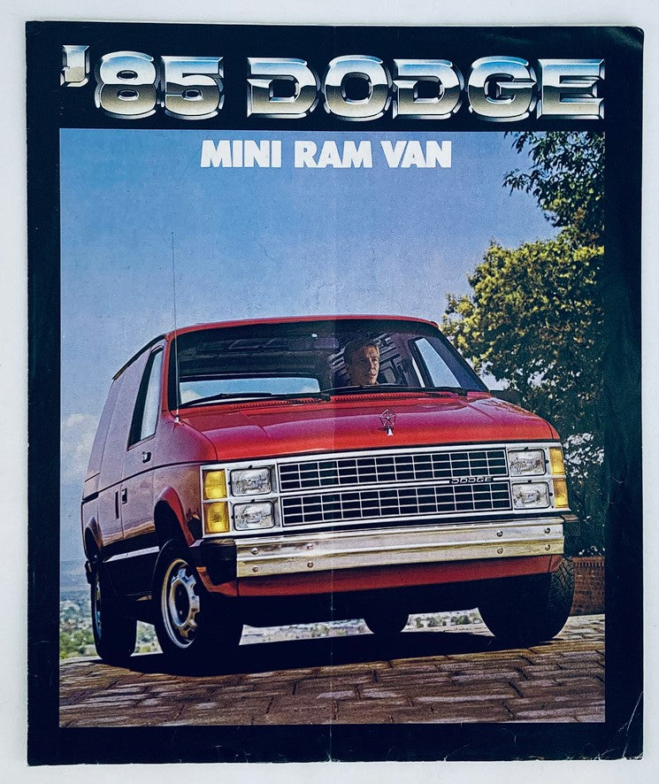 1985 Dodge Mini Ram Van Dealer Showroom Sales Brochure showcasing a red Dodge Mini Ram Van parked in a scenic setting, emphasizing the vehicle's design and features.
