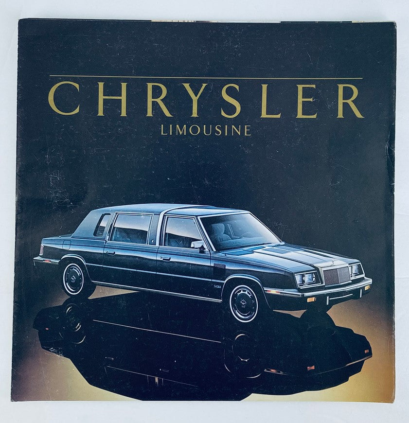 1986 Chrysler Limousine Dealer Showroom Sales Brochure Guide Catalog featuring a stylish black limousine with a glossy finish, highlighting its sleek design and luxurious features.