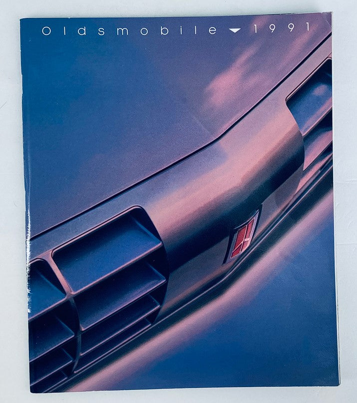 Cover of the 1991 Oldsmobile Lineup Dealer Showroom Sales Brochure Guide Catalog featuring a close-up of the vehicle grille design, showcasing the modern aesthetics of Oldsmobile in 1991.