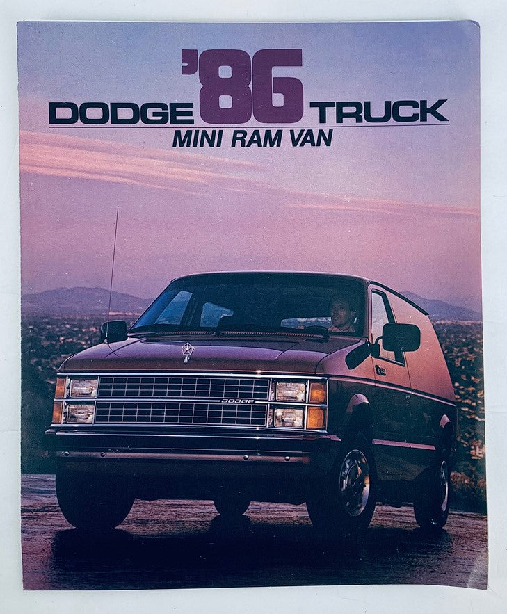 Cover of the 1986 Dodge Truck Mini Ram Van Dealer Showroom Sales Brochure, featuring a Mini Ram Van parked on a scenic mountain backdrop with a sunset sky.