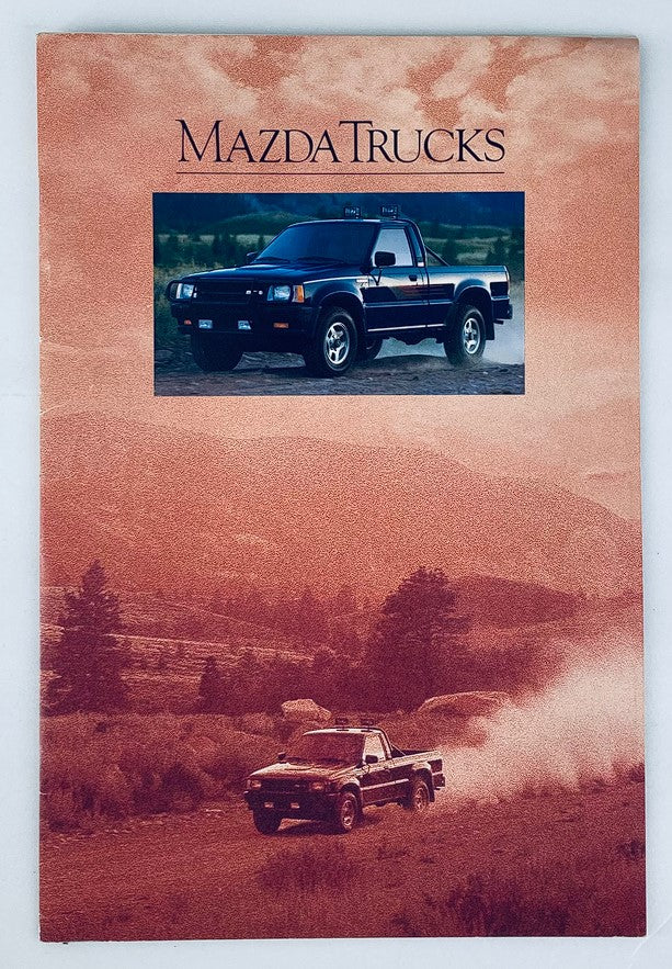 Front cover of the 1990 Mazda Trucks Lineup Dealer Showroom Sales Brochure Guide Catalog featuring a Mazda truck in a scenic outdoor setting.