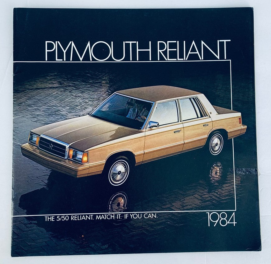 1984 Plymouth Reliant Dealer Showroom Sales Brochure Guide Catalog featuring a gold Plymouth Reliant parked on a reflective surface, showcasing its design and features.