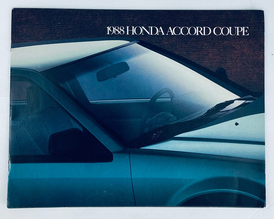 1988 Honda Accord Coupe Dealer Showroom Sales Brochure Guide Catalog, showcasing the exterior design of the vehicle with a focus on the windshield and door details in a moody setting.