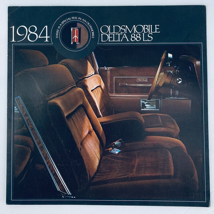 1984 Oldsmobile Delta 88 LS Dealer Showroom Sales Brochure showcasing the interior design, highlighting the comfortable seating and vintage automotive style.