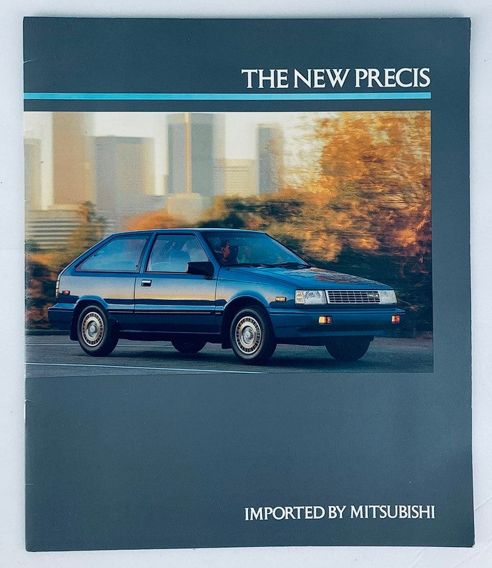 Cover of the 1987 Mitsubishi Precis Dealer Showroom Sales Brochure Guide Catalog featuring a blue Mitsubishi Precis car in front of a city skyline.