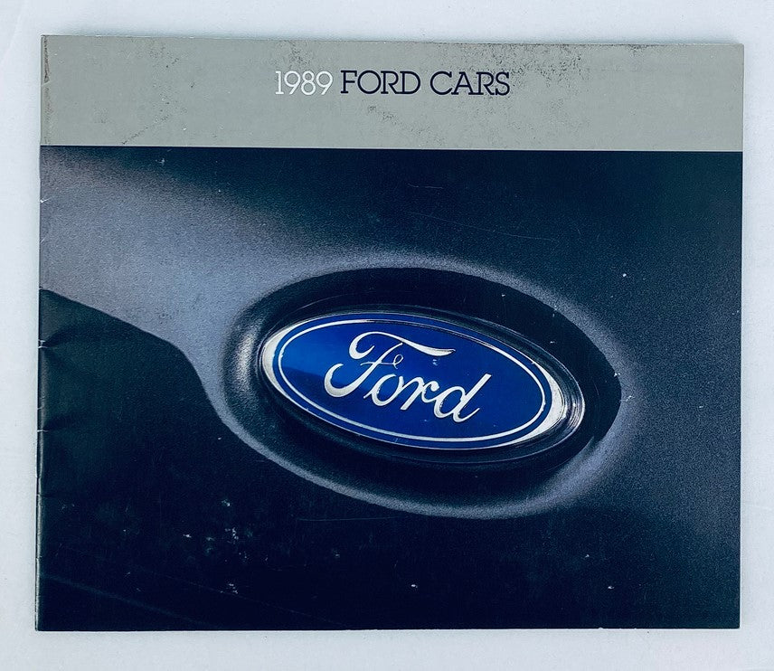 Cover of the 1989 Ford Cars Lineup Dealer Showroom Sales Brochure showcasing the distinct blue oval Ford logo against a sleek black background.