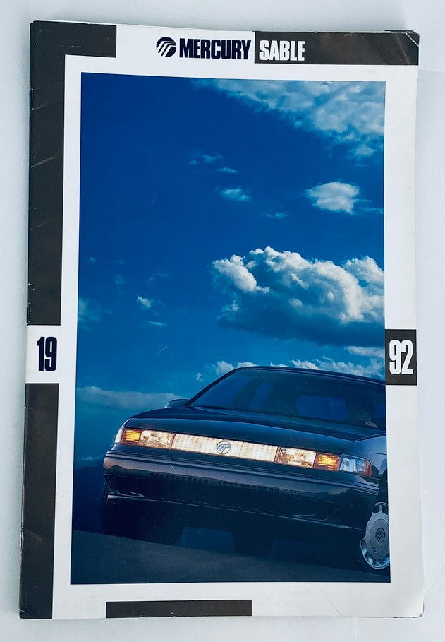 1992 Mercury Sable Dealer Showroom Sales Brochure featuring a sleek black Mercury Sable car against a blue sky backdrop. Ideal for collectors and enthusiasts of automotive literature.