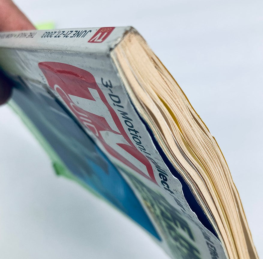 Side view of the TV Guide Magazine June 21 2003, showing the aged pages and spine, emphasizing its vintage condition.